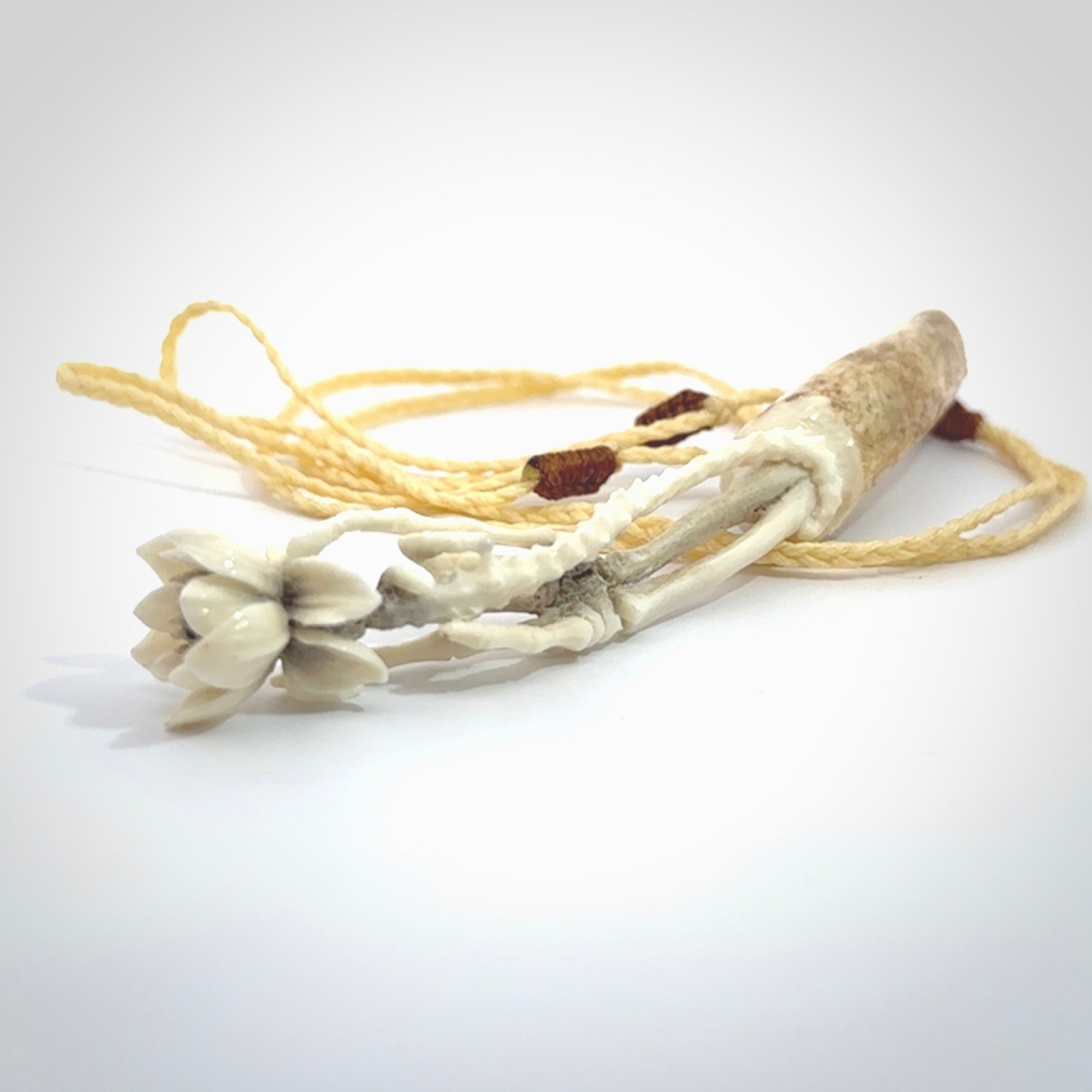 Hand carved deer antler, bone skeleton hand holding a flower pendant online for sale. Creative necklace for lovers of skeletons hand made from deer antler, bone. Free shipping worldwide. We provide this pendant with an adjustable cord.