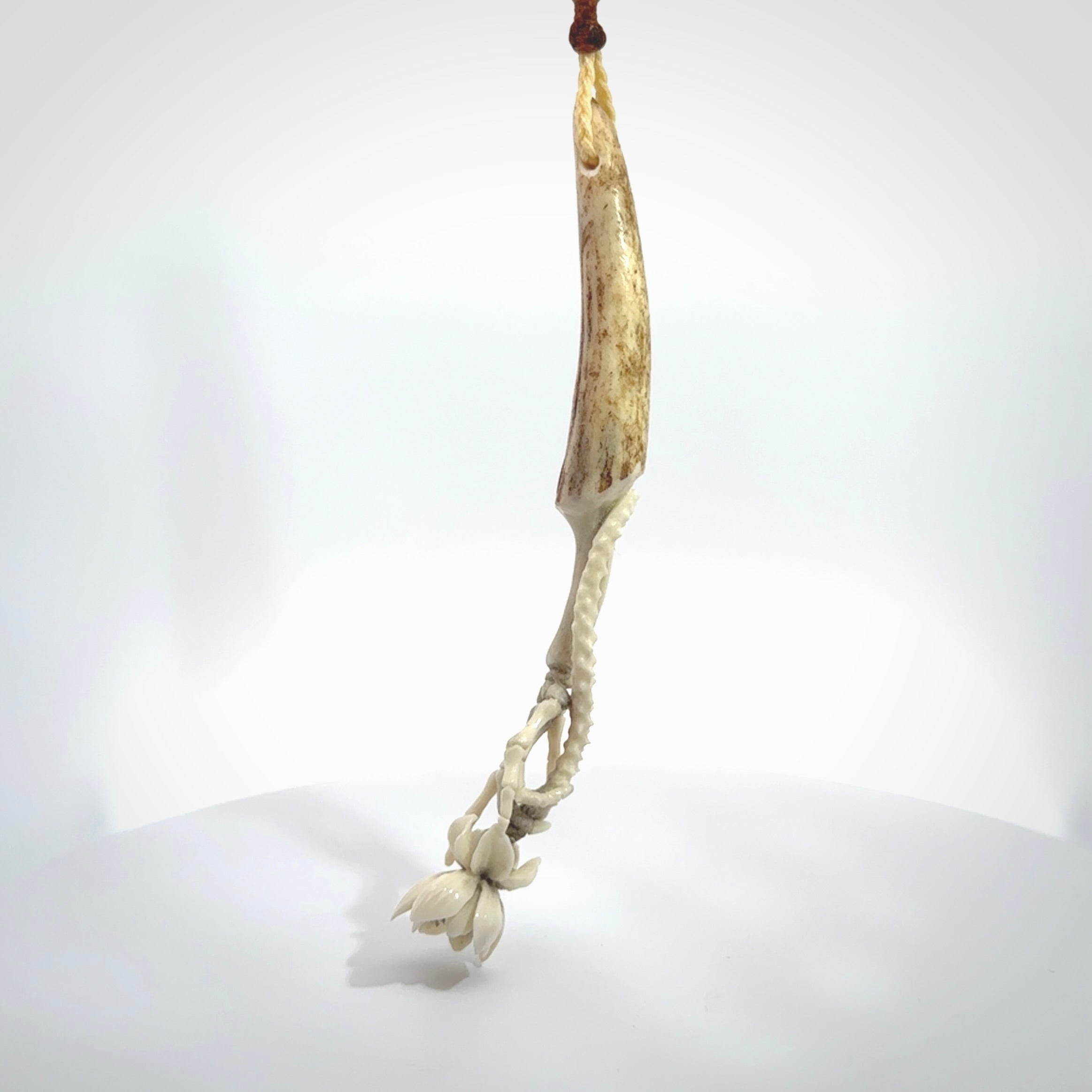 Hand carved deer antler, bone skeleton hand holding a flower pendant online for sale. Creative necklace for lovers of skeletons hand made from deer antler, bone. Free shipping worldwide. We provide this pendant with an adjustable cord.