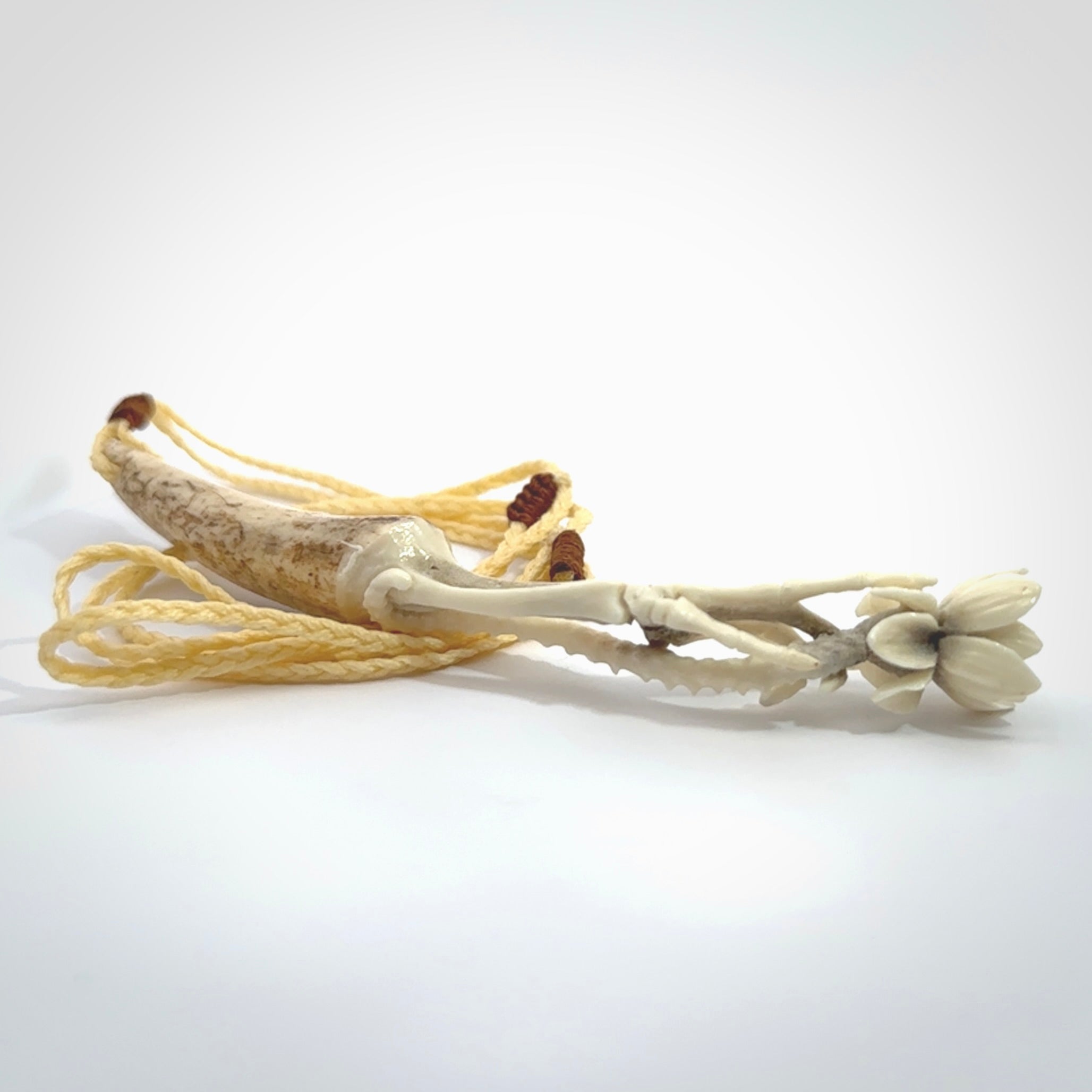 Hand carved deer antler, bone skeleton hand holding a flower pendant online for sale. Creative necklace for lovers of skeletons hand made from deer antler, bone. Free shipping worldwide. We provide this pendant with an adjustable cord.