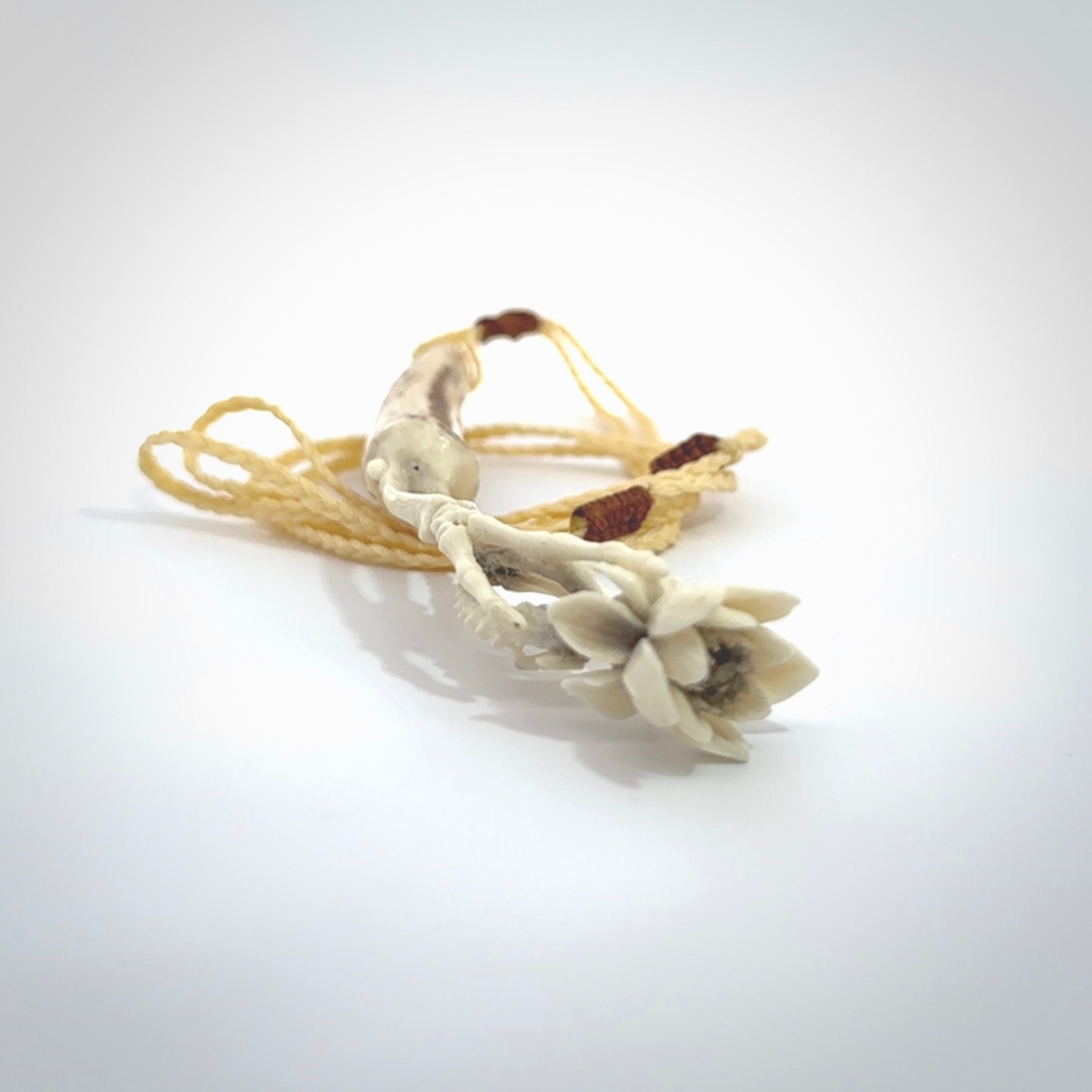 Hand carved deer antler, bone skeleton hand holding a flower pendant online for sale. Creative necklace for lovers of skeletons hand made from deer antler, bone. Free shipping worldwide. We provide this pendant with an adjustable cord.