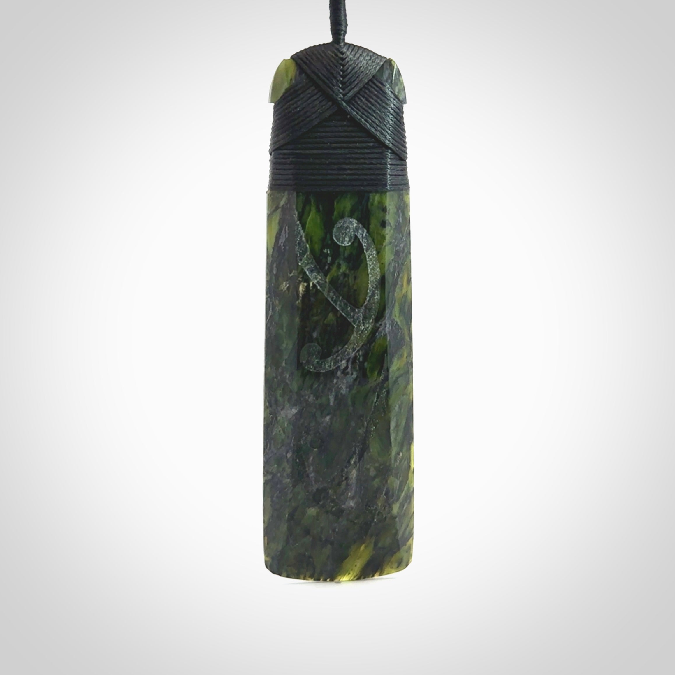 Large Tangiwai Pounamu Toki pendant. Hand carved from a lovely piece of local New Zealand Tangiwai. The quality of the workmanship and design is outstanding - this is a piece you will want to wear all the time. We have suspended this from an adjustable 3-plait black cord and binding.