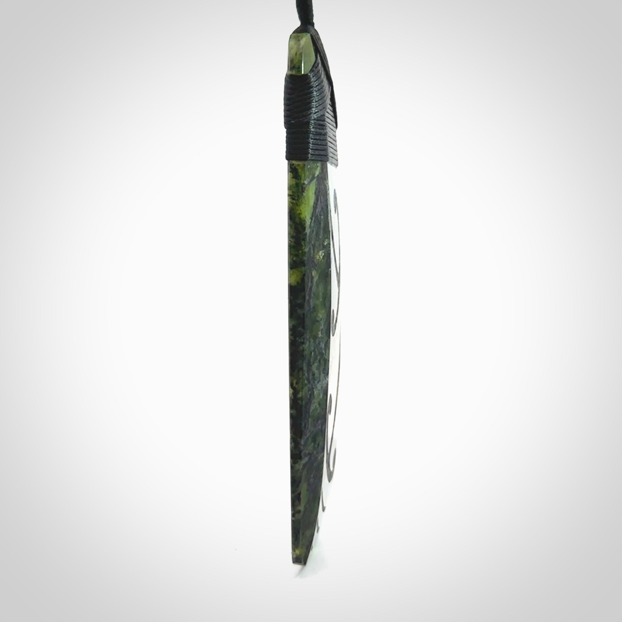 Large Tangiwai Pounamu Toki pendant. Hand carved from a lovely piece of local New Zealand Tangiwai. The quality of the workmanship and design is outstanding - this is a piece you will want to wear all the time. We have suspended this from an adjustable 3-plait black cord and binding.