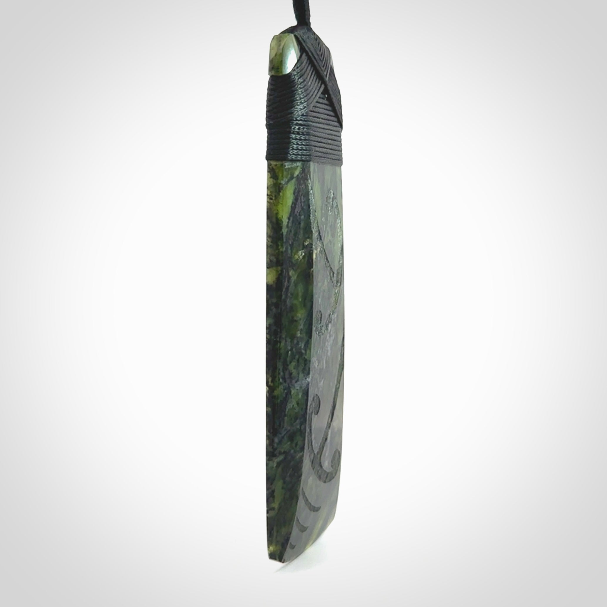 Large Tangiwai Pounamu Toki pendant. Hand carved from a lovely piece of local New Zealand Tangiwai. The quality of the workmanship and design is outstanding - this is a piece you will want to wear all the time. We have suspended this from an adjustable 3-plait black cord and binding.