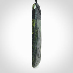 Large Tangiwai Pounamu Toki pendant. Hand carved from a lovely piece of local New Zealand Tangiwai. The quality of the workmanship and design is outstanding - this is a piece you will want to wear all the time. We have suspended this from an adjustable 3-plait black cord and binding.