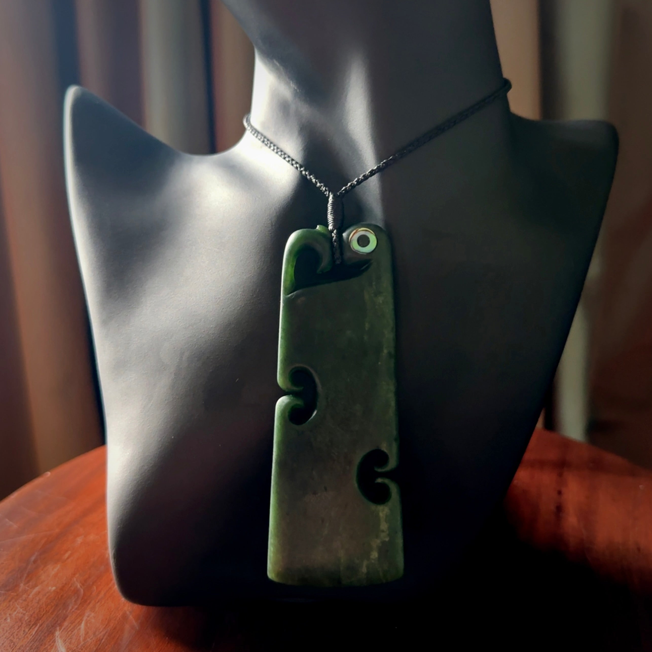 This is a beautiful large New Zealand Jade, pounamu Manaia Toki pendant with double Koru and Paua Shell eyes. Hand carved for us by Kyohei Noguchi. It is bound with an adjustable black coloured cord which is length adjustable. Free worldwide shipping. We have one only.