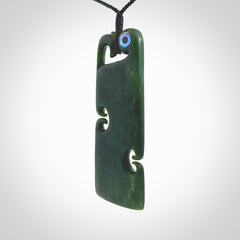 This is a beautiful large New Zealand Jade, pounamu Manaia Toki pendant with double Koru and Paua Shell eyes. Hand carved for us by Kyohei Noguchi. It is bound with an adjustable black coloured cord which is length adjustable. Free worldwide shipping. We have one only.