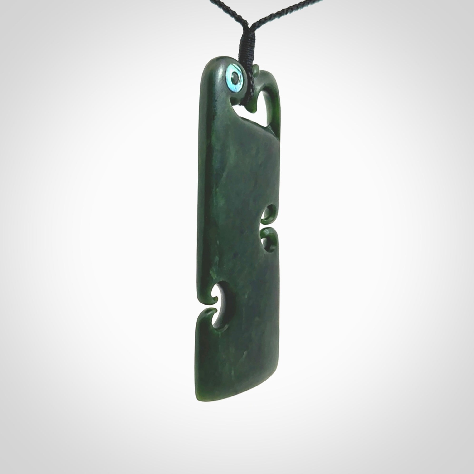 This is a beautiful large New Zealand Jade, pounamu Manaia Toki pendant with double Koru and Paua Shell eyes. Hand carved for us by Kyohei Noguchi. It is bound with an adjustable black coloured cord which is length adjustable. Free worldwide shipping. We have one only.