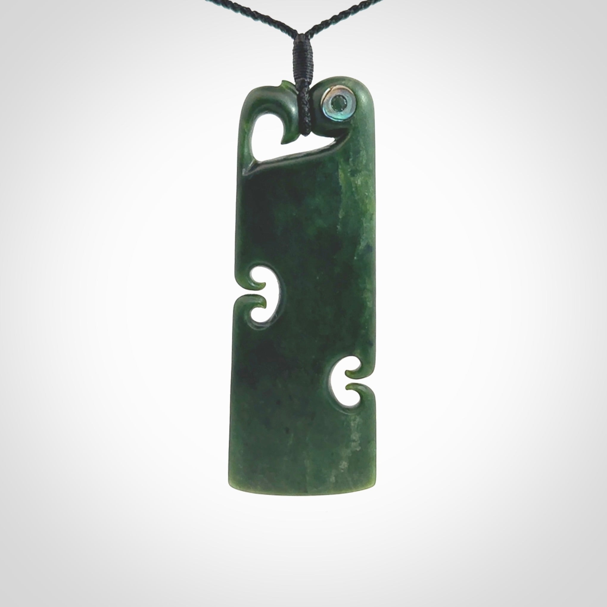 This is a beautiful large New Zealand Jade, pounamu Manaia Toki pendant with double Koru and Paua Shell eyes. Hand carved for us by Kyohei Noguchi. It is bound with an adjustable black coloured cord which is length adjustable. Free worldwide shipping. We have one only.