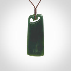 This is a lovely New Zealand Jade, pounamu drop pendant. Hand carved for us by Kyohei Noguchi. It is bound with an adjustable brown coloured cord which is length adjustable. Free worldwide shipping.