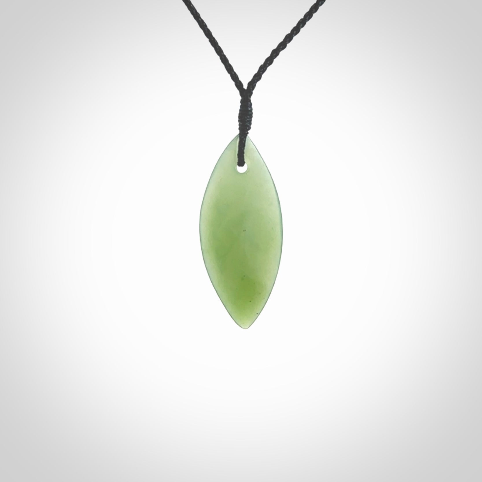 One only small sized New Zealand Inanga jade drop pendant. Hand carved in New Zealand by Ric Moor, jade artist, for NZ Pacific. Provided with adjustable black cord.