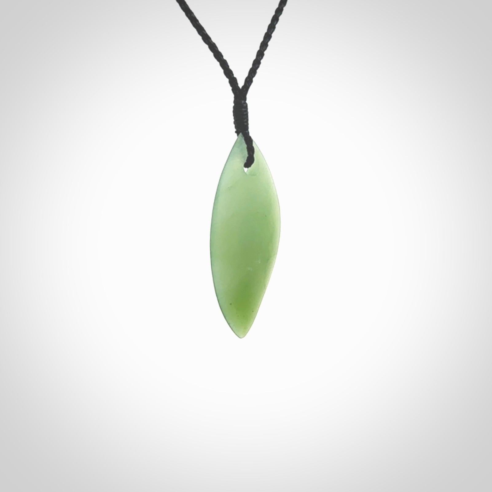 One only small sized New Zealand Inanga jade drop pendant. Hand carved in New Zealand by Ric Moor, jade artist, for NZ Pacific. Provided with adjustable black cord.