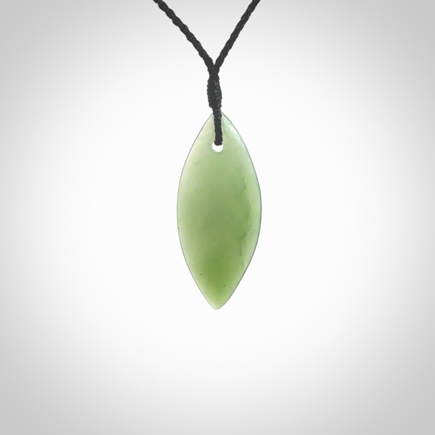 One only small sized New Zealand Inanga jade drop pendant. Hand carved in New Zealand by Ric Moor, jade artist, for NZ Pacific. Provided with adjustable black cord.