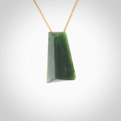 This is a lovely New Zealand Jade, pounamu drop pendant. Hand carved for us by Ric Moor. It is bound with an adjustable beige coloured cord which is length adjustable. Free worldwide shipping. The light reveals the internal structure and colour of the stone beautifully.