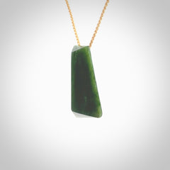 This is a lovely New Zealand Jade, pounamu drop pendant. Hand carved for us by Ric Moor. It is bound with an adjustable beige coloured cord which is length adjustable. Free worldwide shipping. The light reveals the internal structure and colour of the stone beautifully.