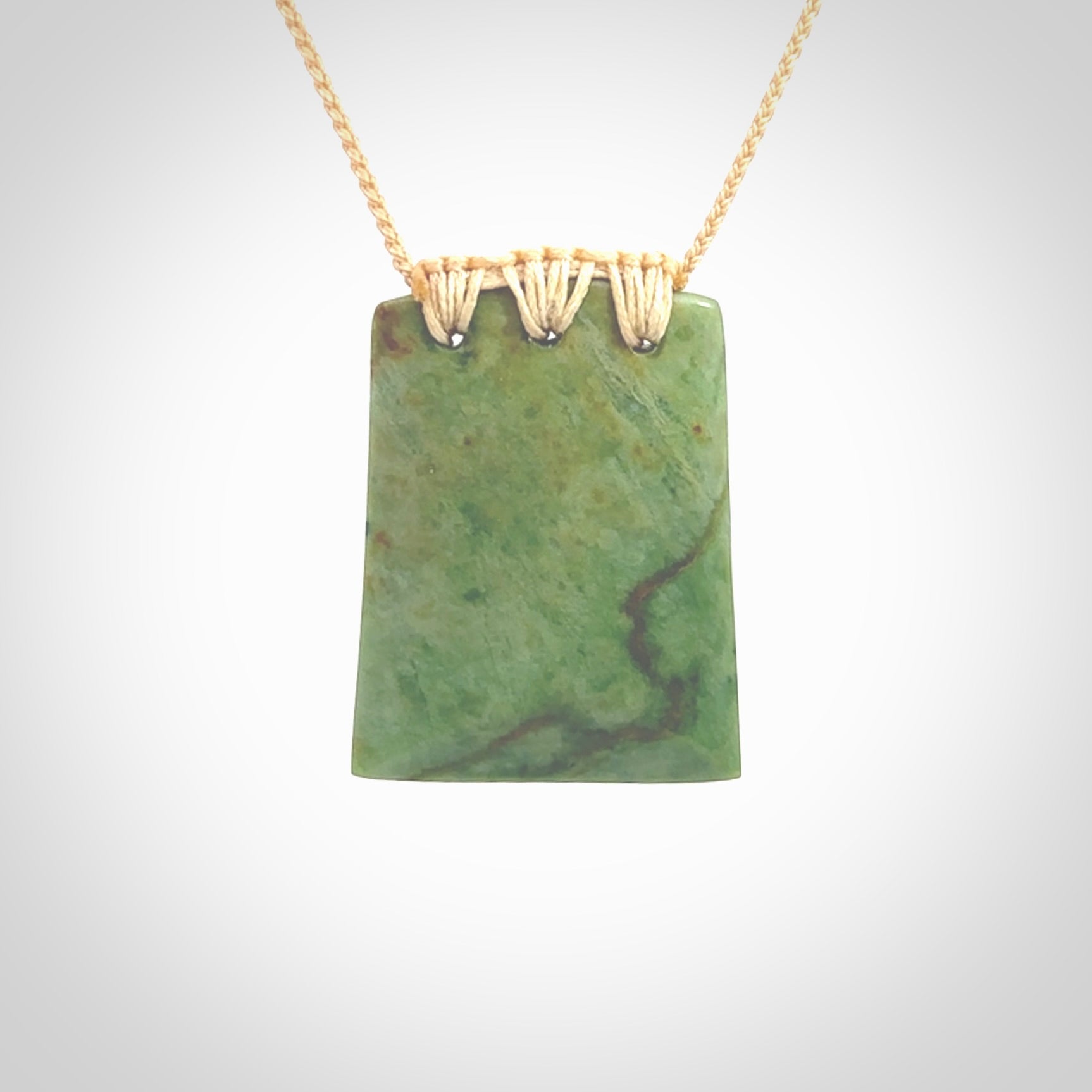 This is a lovely New Zealand Jade, pounamu drop pendant. Hand carved for us by Ric Moor. It is bound with an adjustable beige coloured cord which is length adjustable. Free worldwide shipping.