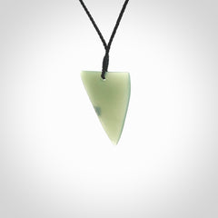 This picture shows a hand carved jade drop pendant by Ric Moor. The jade is a wonderful light, semi-translucent, green. It is suspended from a black adjustable cord. Delivery is free worldwide.