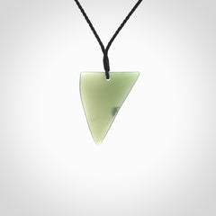 This picture shows a hand carved jade drop pendant by Ric Moor. The jade is a wonderful light, semi-translucent, green. It is suspended from a black adjustable cord. Delivery is free worldwide.