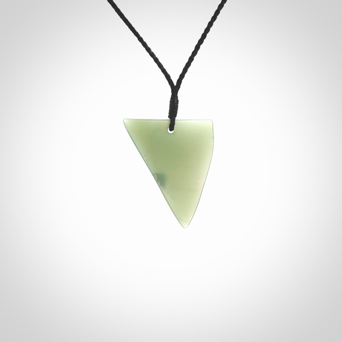 This picture shows a hand carved jade drop pendant by Ric Moor. The jade is a wonderful light, semi-translucent, green. It is suspended from a black adjustable cord. Delivery is free worldwide.