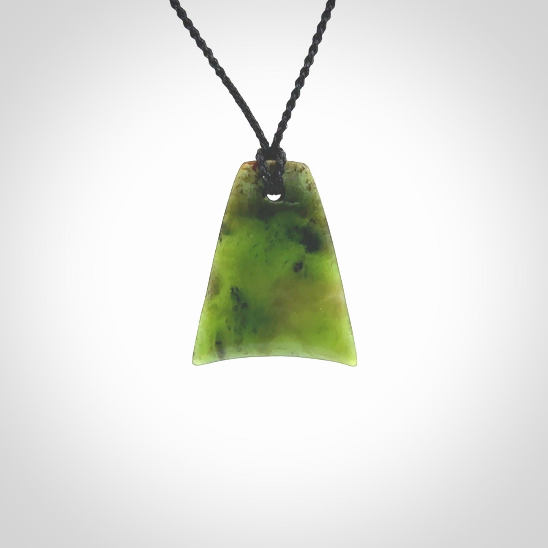 This is a lovely New Zealand Jade, pounamu drop pendant. Hand carved for us by Ric Moor. It is bound with an adjustable black coloured cord which is length adjustable. Free worldwide shipping.