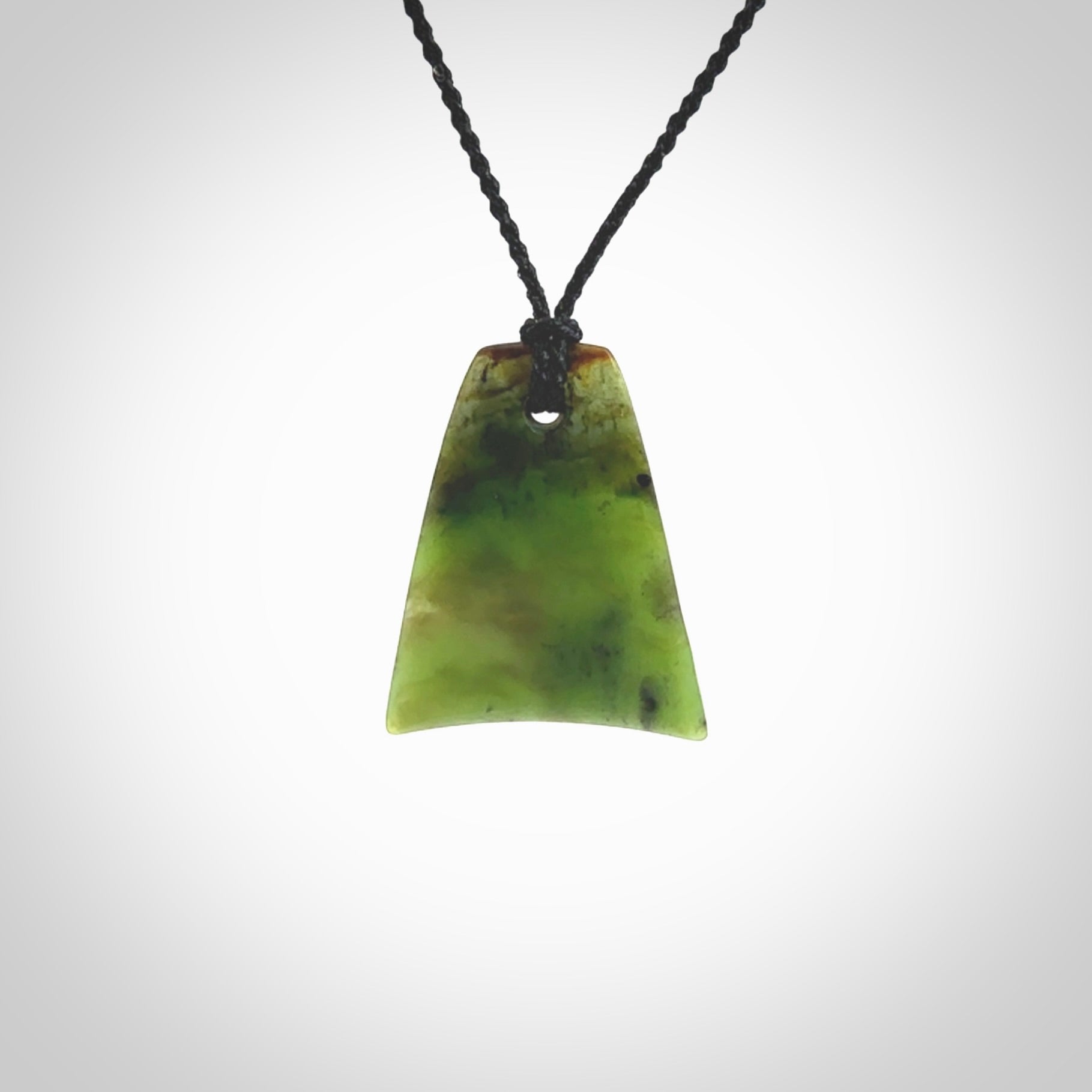 This is a lovely New Zealand Jade, pounamu drop pendant. Hand carved for us by Ric Moor. It is bound with an adjustable black coloured cord which is length adjustable. Free worldwide shipping.