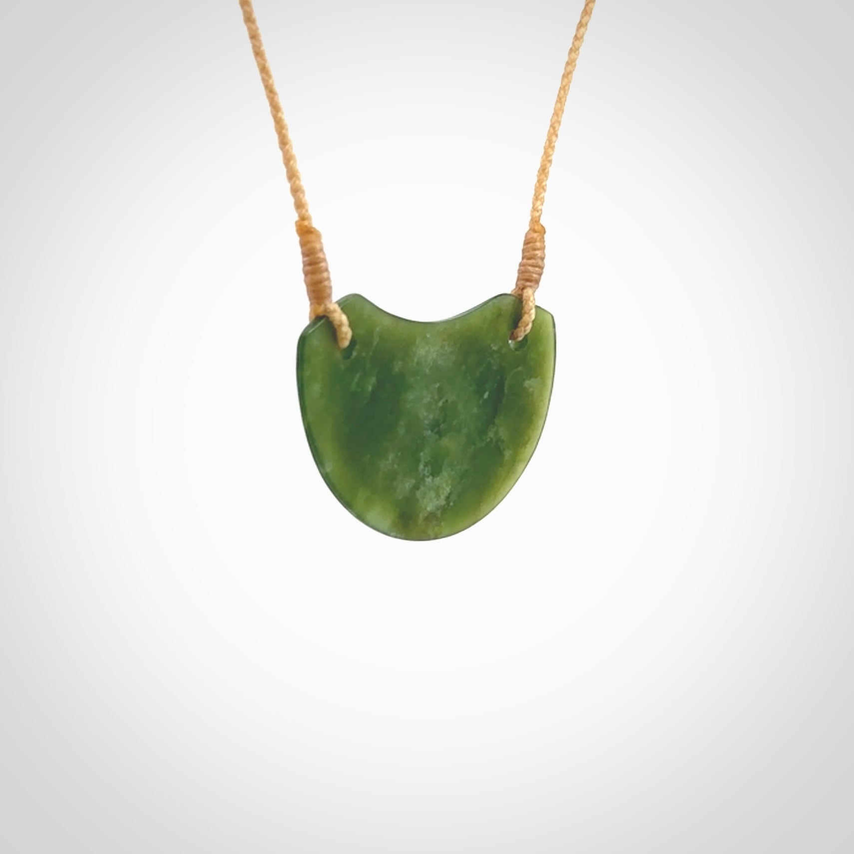 Hand carved pounamu small shield drop pendant. Jade necklace hand made in New Zealand. A contemporary drop pendant carved from rare New Zealand jade. NZ Pacific jade jewellery for sale online.