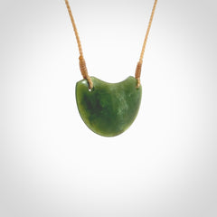 Hand carved pounamu small shield drop pendant. Jade necklace hand made in New Zealand. A contemporary drop pendant carved from rare New Zealand jade. NZ Pacific jade jewellery for sale online.