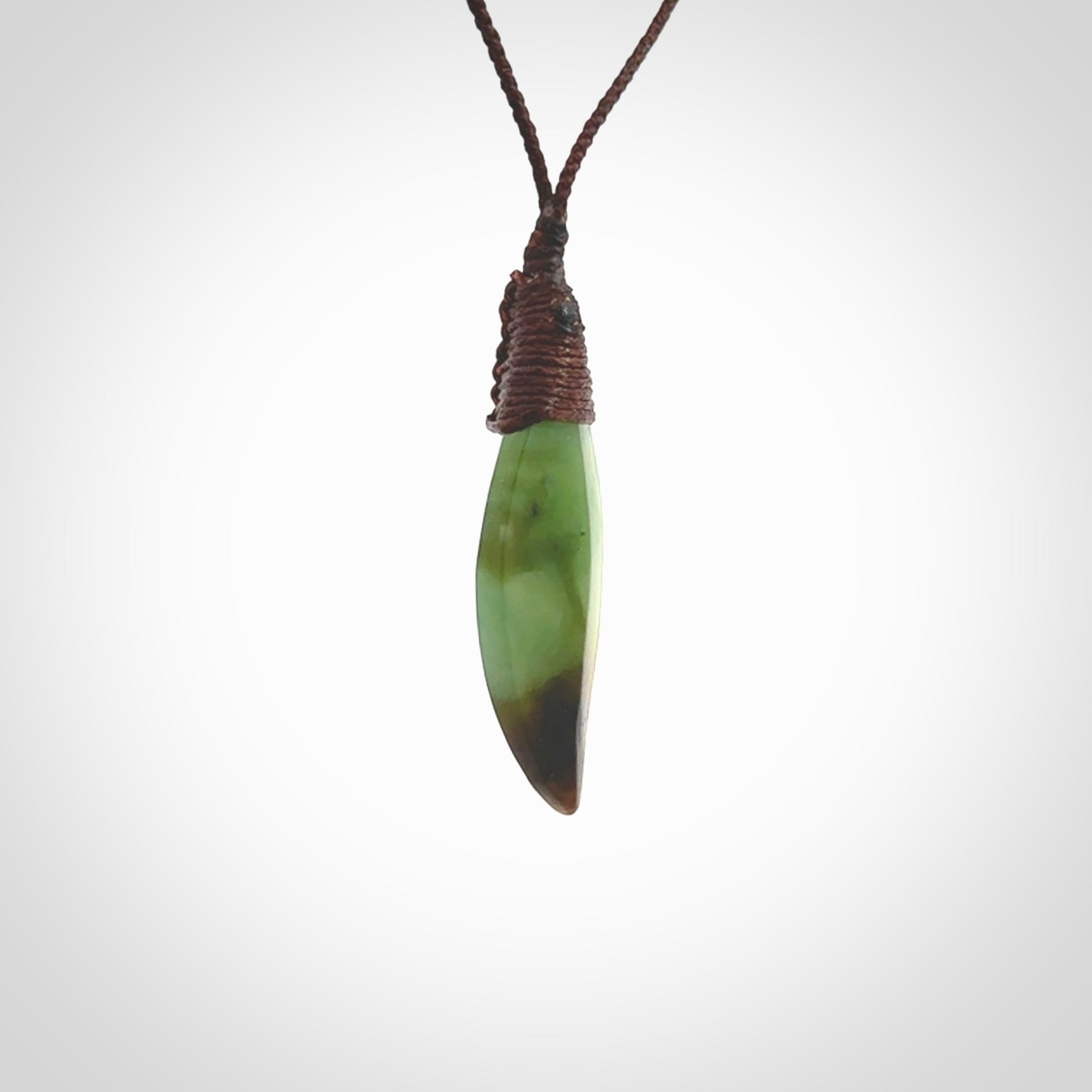 This is a lovely New Zealand Totoweka Jade, pounamu drop pendant. Hand carved for us by Ric Moor. It is bound with an adjustable brown coloured cord which is length adjustable. Free worldwide shipping.