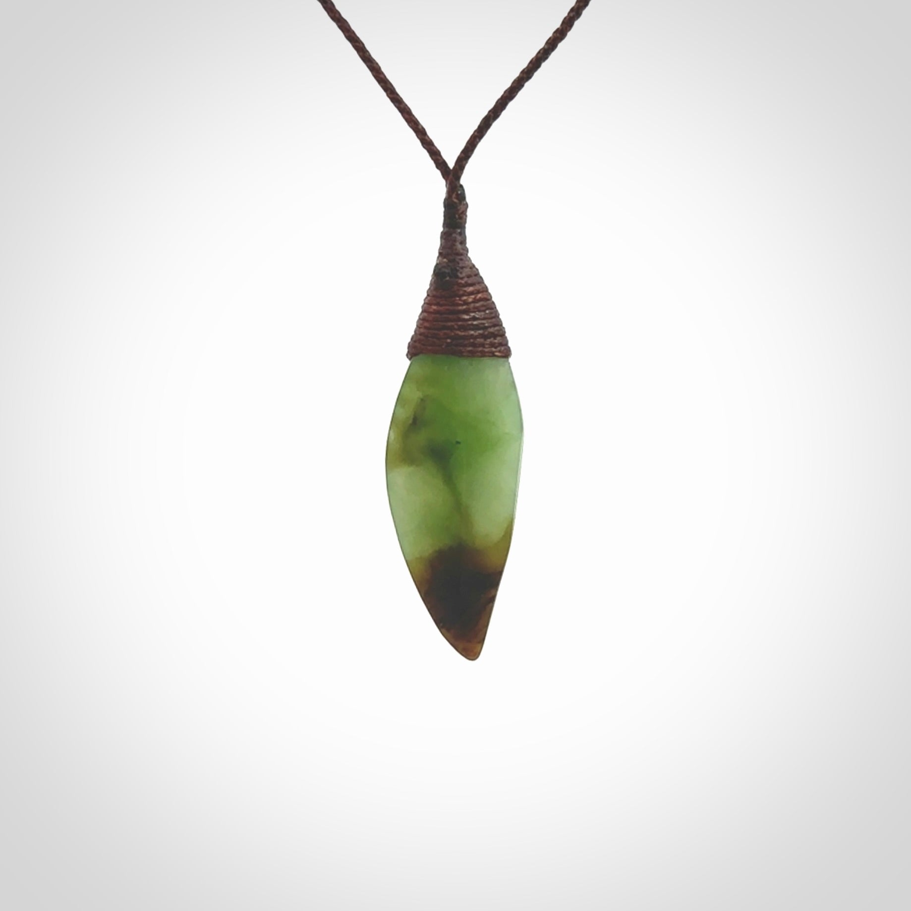 This is a lovely New Zealand Totoweka Jade, pounamu drop pendant. Hand carved for us by Ric Moor. It is bound with an adjustable brown coloured cord which is length adjustable. Free worldwide shipping.