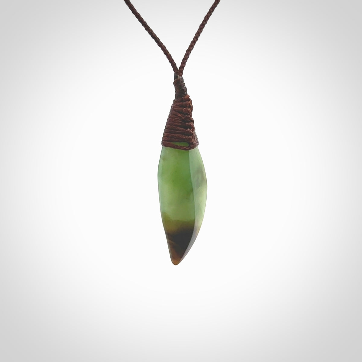 This is a lovely New Zealand Totoweka Jade, pounamu drop pendant. Hand carved for us by Ric Moor. It is bound with an adjustable brown coloured cord which is length adjustable. Free worldwide shipping.