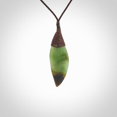 This is a lovely New Zealand Totoweka Jade, pounamu drop pendant. Hand carved for us by Ric Moor. It is bound with an adjustable brown coloured cord which is length adjustable. Free worldwide shipping.