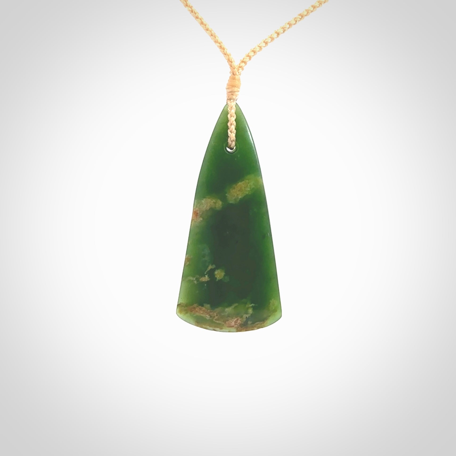 This photo shows a large jade drop shaped pendant. It a a lovely green and orange jade. The cord is a four plait beige and is adjustable in length. One only large, contemporary drop necklace from Jade, by Ric Moor.