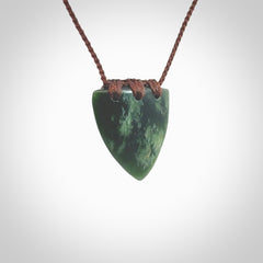 This photo shows a jade drop shaped pendant. It a a lovely deep green jade. The cord is a four plait brown and is adjustable in length. One only medium, contemporary drop necklace from Jade, by Ric Moor.