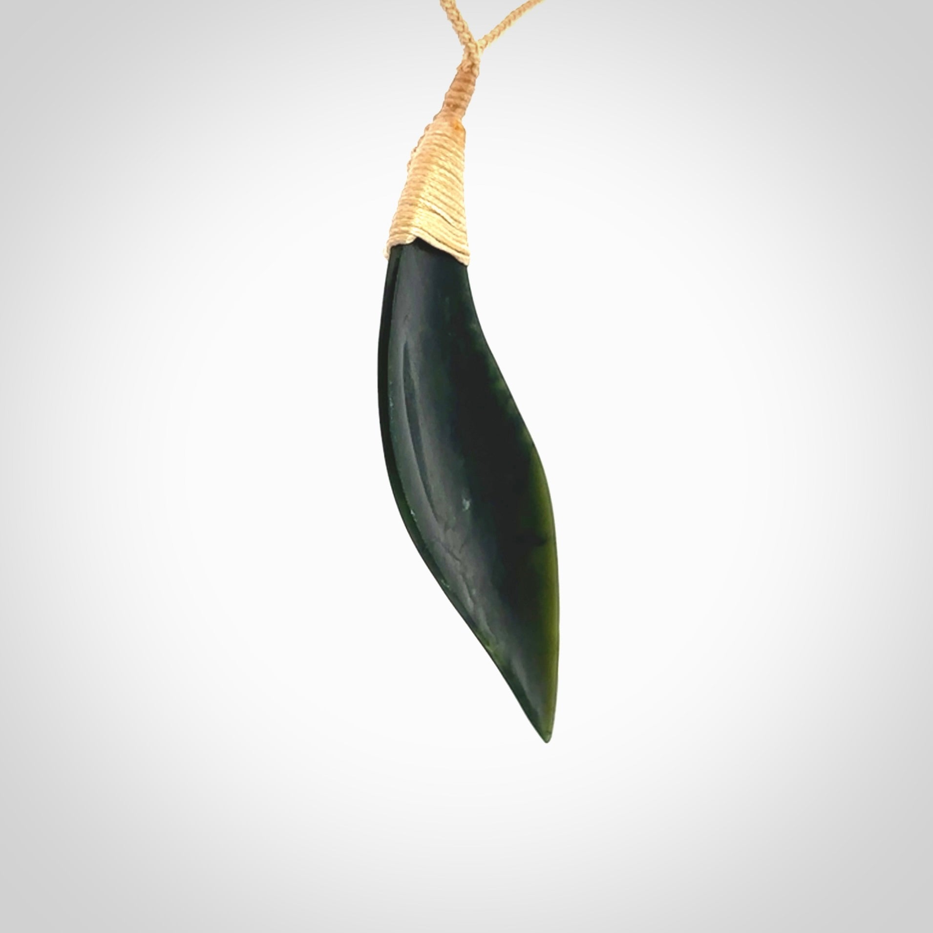 One only large sized New Zealand jade drop pendant. Hand carved in New Zealand by Ric Moor, jade artist, for NZ Pacific. Contemporary drop necklace with adjustable beige cord, packaged in a woven kete pouch.