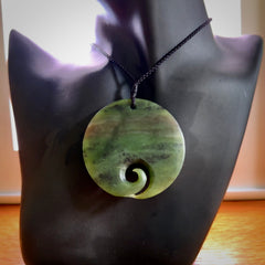 This koru, is carved from a very striking New Zealand Totoweka jade. Pounamu koru pendant hand made by Ric Moor. One only Koru necklace provided with a black adjustable cord.