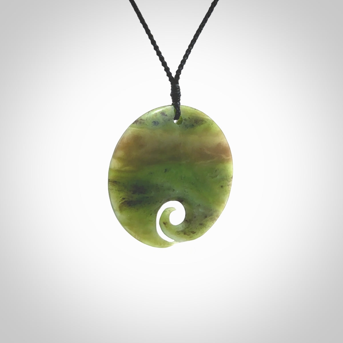 This koru, is carved from a very striking New Zealand Totoweka jade. Pounamu koru pendant hand made by Ric Moor. One only Koru necklace provided with a black adjustable cord.