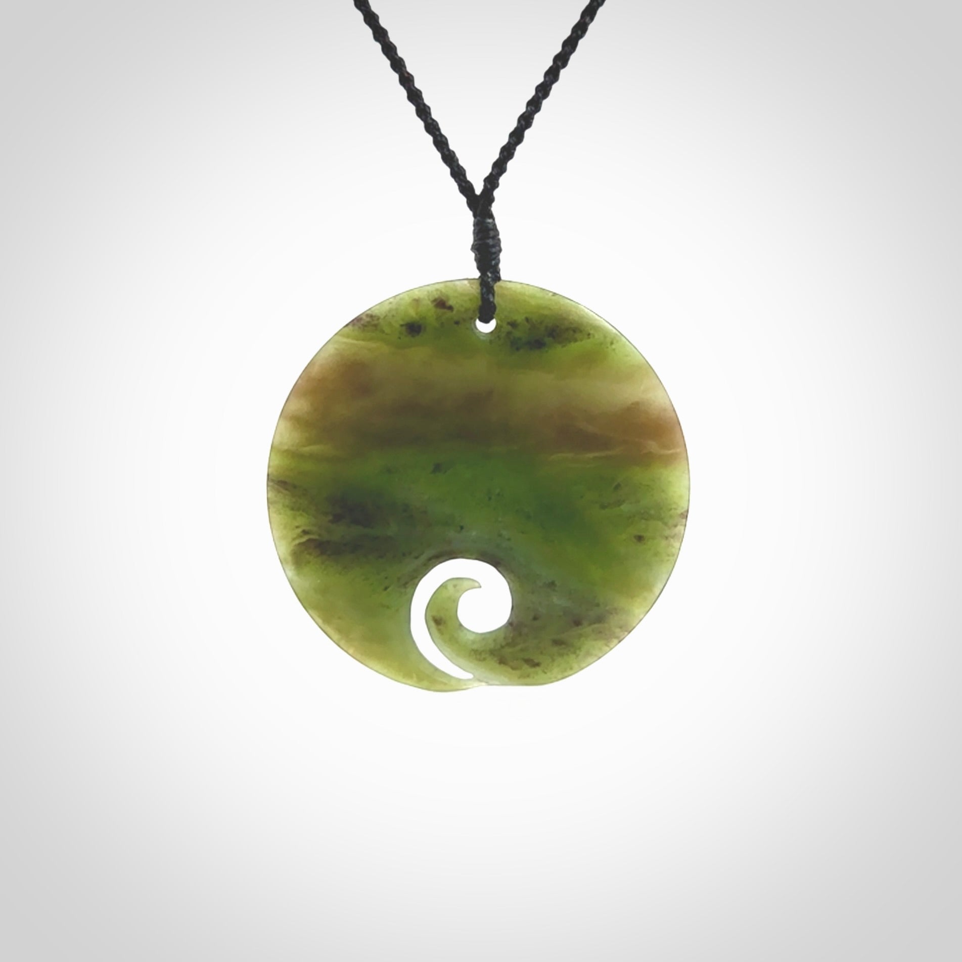 This koru, is carved from a very striking New Zealand Totoweka jade. Pounamu koru pendant hand made by Ric Moor. One only Koru necklace provided with a black adjustable cord.