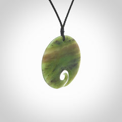 This koru, is carved from a very striking New Zealand Totoweka jade. Pounamu koru pendant hand made by Ric Moor. One only Koru necklace provided with a black adjustable cord.