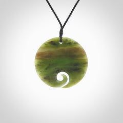 This koru, is carved from a very striking New Zealand Totoweka jade. Pounamu koru pendant hand made by Ric Moor. One only Koru necklace provided with a black adjustable cord.