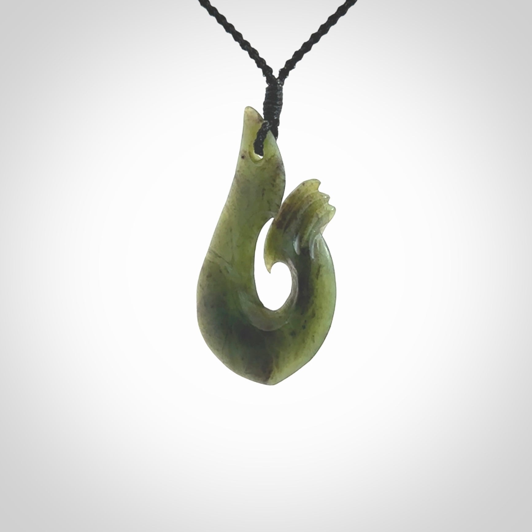 This hook, is carved from a very striking New Zealand jade. It is both intricate and simple in design - it has hidden folds and smooth curves. A piece to be worn or displayed - the carving and the jade are both magnificent.