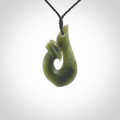 This hook, is carved from a very striking New Zealand jade. It is both intricate and simple in design - it has hidden folds and smooth curves. A piece to be worn or displayed - the carving and the jade are both magnificent.