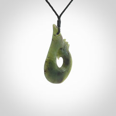 This hook, is carved from a very striking New Zealand jade. It is both intricate and simple in design - it has hidden folds and smooth curves. A piece to be worn or displayed - the carving and the jade are both magnificent.