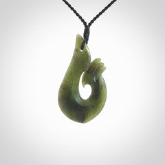 This hook, is carved from a very striking New Zealand jade. It is both intricate and simple in design - it has hidden folds and smooth curves. A piece to be worn or displayed - the carving and the jade are both magnificent.