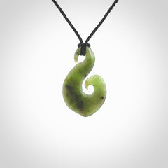 This koru/matau, is carved from a very striking New Zealand jade. It is both intricate and simple in design - it has hidden folds and smooth curves. A piece to be worn, the carving and the jade are both magnificent.