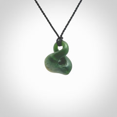 This piece is a fine, delicate drop shaped, single twist pendant. It was carved for us by Ric Moor from a lovely deep green piece of New Zealand jade. It is suspended on an black four plaited braided cord that is length adjustable.