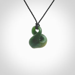 This piece is a fine, delicate drop shaped, single twist pendant. It was carved for us by Ric Moor from a lovely deep green piece of New Zealand jade. It is suspended on an black four plaited braided cord that is length adjustable.