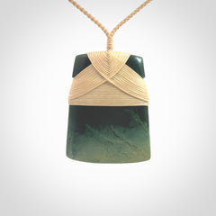 Hand carved from a lovely piece of local New Zealand Jade, a large and chunky Toki pendant. The quality of the workmanship and design is outstanding - this is a piece you will want to wear all the time. We have suspended this from a 4-plait beige cord which can be adjusted with a couple of slip knots and beige binding.