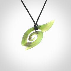 This photo shows a koru pendant carved from New Zealand Jade. The artist, Shaun Gardiner, has carved this beautifully. We provide this piece with an adjustable black cord. This is a fantastic work of art, we have one only.