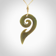 This photo shows a koru pendant carved from New Zealand Jade. The artist, Shaun Gardiner, has carved this beautifully. We provide this piece with an adjustable oat cord. This is a fantastic work of art, we have one only.