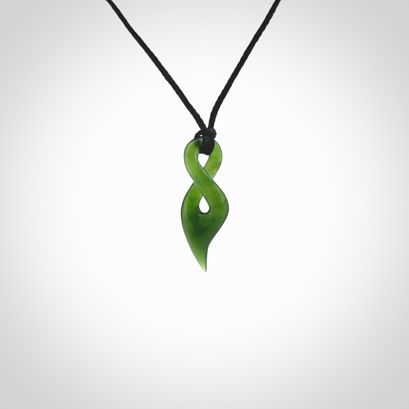 Hand carved small sized, New Zealand jade twist pendant. Carved in New Zealand by NZ Pacific. Hand made small Jade twist with adjustable black cord by Shaun Gardiner.