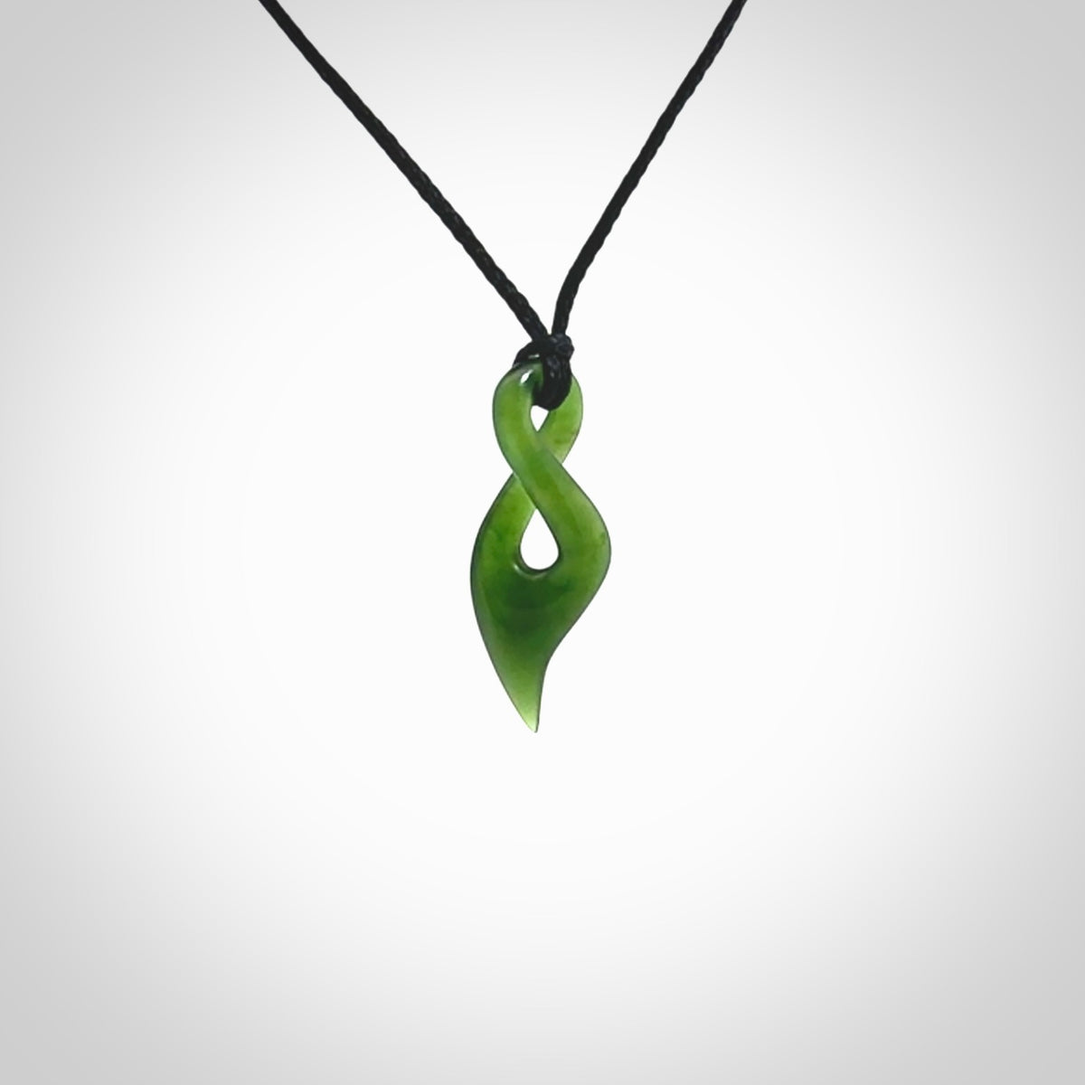 Hand carved small sized, New Zealand jade twist pendant. Carved in New Zealand by NZ Pacific. Hand made small Jade twist with adjustable black cord by Shaun Gardiner.